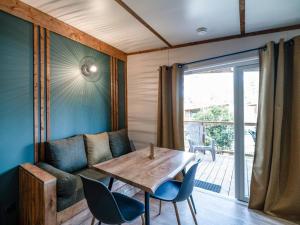 a living room with a couch and a table at Camping LANDAE in Ondres +12 photos