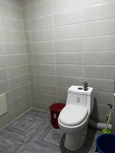a bathroom with a white toilet in a room at Spacious and sunny comfy apartment in Oran +2 photos