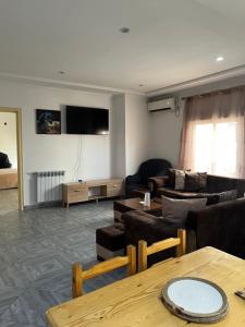 a living room with a couch and a table at Spacious and sunny comfy apartment in Oran