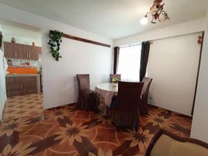 a kitchen with a table and chairs in a room at Shekina Huaraz Departament in Huaraz
