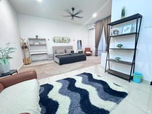 a living room with a couch and a rug at Zhara Homestay in Ipoh
