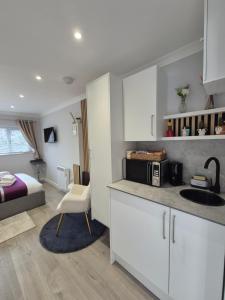a kitchen with a sink and a bed in a room at Pro Stay Studio in Fort William