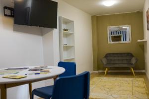 a small room with a table and chairs and a chair at Da Vinci Apartmanok in Eger