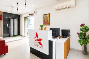 a lobby with a reception desk and a tv at Hotel Kalyan in Rajkot