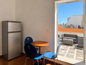 a kitchen with a table and chairs and a window at Monte Cuccu Bed & Breakfast in Cerfignano