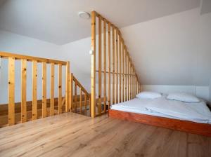 a bedroom with a bed and a wooden floor at Chatki Niwkii u Zbója Studio z antresolą in Krościenko +38 photos