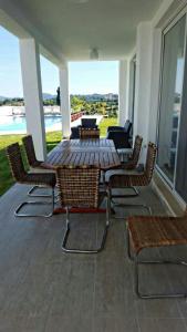 a patio with a table and chairs on a porch at Villa Lina Kerkira in Gouvia