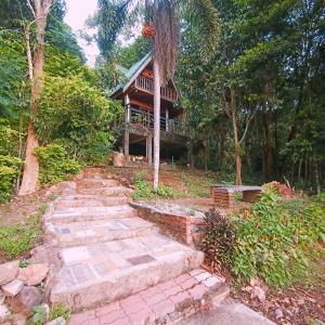 a house in the woods with stairs leading up to it at SN Garden in Ban Bo Hin