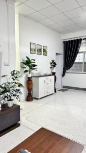 a large living room with potted plants in it at Triple T House in Hat Yai