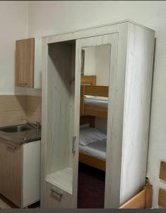 ajar door of a room with a bunk bed at Apartmani BALKAN in Sjenica +18 photos