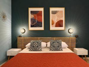 a bedroom with a red bed with two pillows at B&B La Borasca - Apartments in Casalpusterlengo