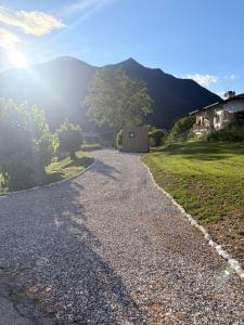 a gravel road with a house in the background at Everest Experience in Paluzza
