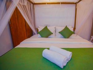 a bedroom with a bed with two pillows on it at villa Senoa in Ahangama +15 photos