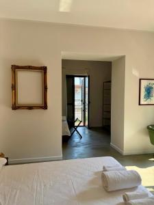 a bedroom with a bed and a mirror on the wall at Nice Sea Suite in Salerno