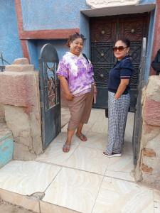 two women standing in front of a door at Abo Orabi Guest House in Aswan