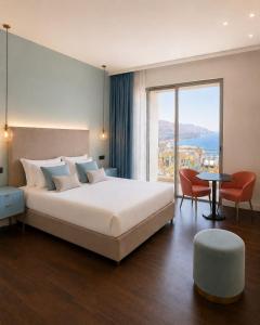 a bedroom with a large bed and a large window at Amaurusa Boutique Hotel in Taormina