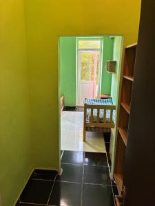 a room with green and yellow walls and a door at Tolia in Ureki +10 photos