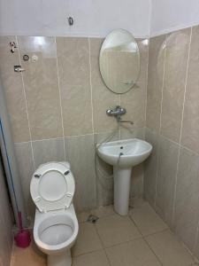 a bathroom with a toilet and a sink at Tolia in Ureki