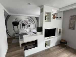 a living room with a tv and a wall at Apartment Ferienwohnung in Sulzbach