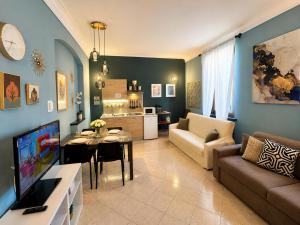 a living room with a couch and a dining room at B&B La Borasca - Apartments in Casalpusterlengo