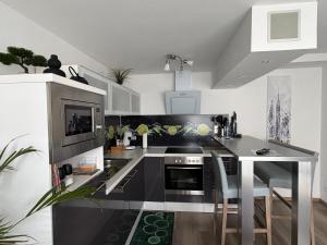 a kitchen with a black and white counter top at Apartment Ferienwohnung in Sulzbach +12 photos