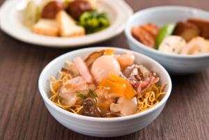 three bowls of food on a wooden table at Dormy Inn Nagasaki Shinchichukagai in Nagasaki