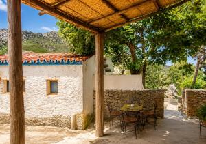 a patio with a table and chairs in front of a building at Caiat Lounge Refuge , Mountain Lodge near Akchour Waterfalls in Taghzoute