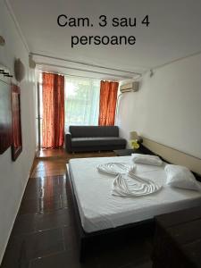 a bedroom with a bed in a room with a couch at Complex GEC-HISTRIA Mamaia in Mamaia +34 photos