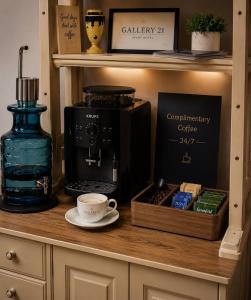 a coffee maker and a cup on a shelf at Apart-HOTEL GALLERY 21 in Lviv