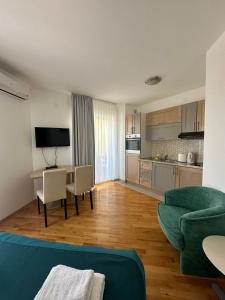 a living room with a couch and a table with chairs at LotusApart in Premantura