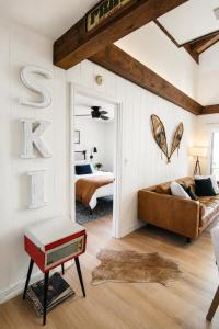 a bedroom with a bed and a large letter s on the wall at Modern Chalet Hot Tub Game Loft 1 Mi to Skiing in Beech Mountain