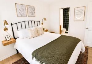 a bedroom with a large bed with white sheets and pillows at Modern Chalet Hot Tub Game Loft 1 Mi to Skiing in Beech Mountain