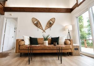 a living room with a couch and butterflies on the wall at Modern Chalet Hot Tub Game Loft 1 Mi to Skiing in Beech Mountain