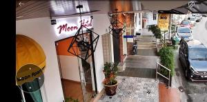 a building with cars parked on the side of a street at Moon Hotel BRINCHANG Town in Brinchang