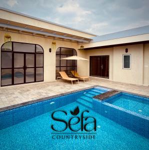 a swimming pool in front of a building at Sefa Countryside in Sukhi Sewānia +8 photos