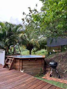 a hot tub sitting on top of a wooden deck at Villas smoothie SYCARO in Le François