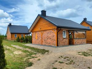 a large brick building with a garage at Przystanek Ładnówko in Kruszyny Szlacheckie