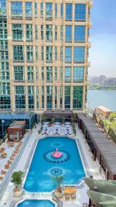 a large building with a large pool in front of it at Four Seasons Cairo At The First Residence in Cairo
