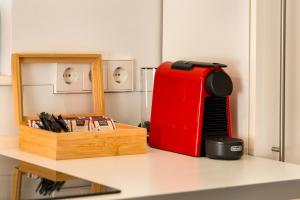 a red suitcase sitting on a counter next to a wooden box at Mola Apartments- Trendiges Apartment in der City-Nähe Dortmund-Terrasse-3 Gäste-WLAN in Herdecke