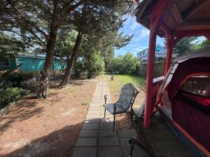a chair sitting on a patio next to a tent at DiscoCat Studios in Ocracoke