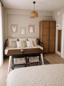 a bedroom with a bed and a table and chairs at Friends' Place Trikala in Tríkala