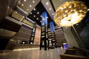 a lobby with a large chandelier in a building at Regal Riverside Hotel in Hong Kong