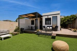 a small house with a yard with a lawn at Sun, Mountain & Adventure in Arad