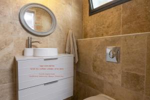 a bathroom with a sink and a mirror at Sun, Mountain & Adventure in Arad +16 photos