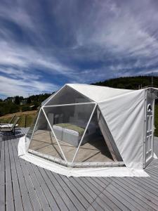 a tent on top of a wooden deck at Džipsi glamping resort in Sarajevo