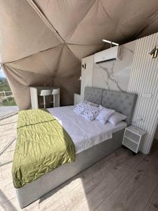 a bedroom with a bed in a tent at Džipsi glamping resort in Sarajevo