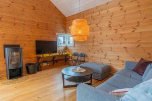 a living room with a couch and a table at Stranda Fjellgrend 36B in Stranda