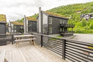 a wooden deck with a wooden table on a house at Stranda Fjellgrend 36B in Stranda