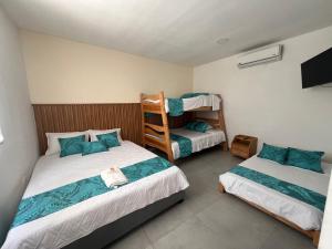 a bedroom with two beds and a bunk bed at CASA HOTEL SANTA INES in Mompós