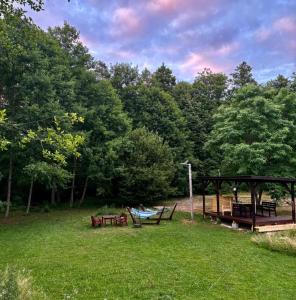 a group of picnic tables and benches in a park at Apartament Graal Roztocza in Rebizanty